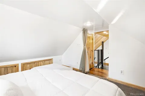 a bedroom with a bed and a large window