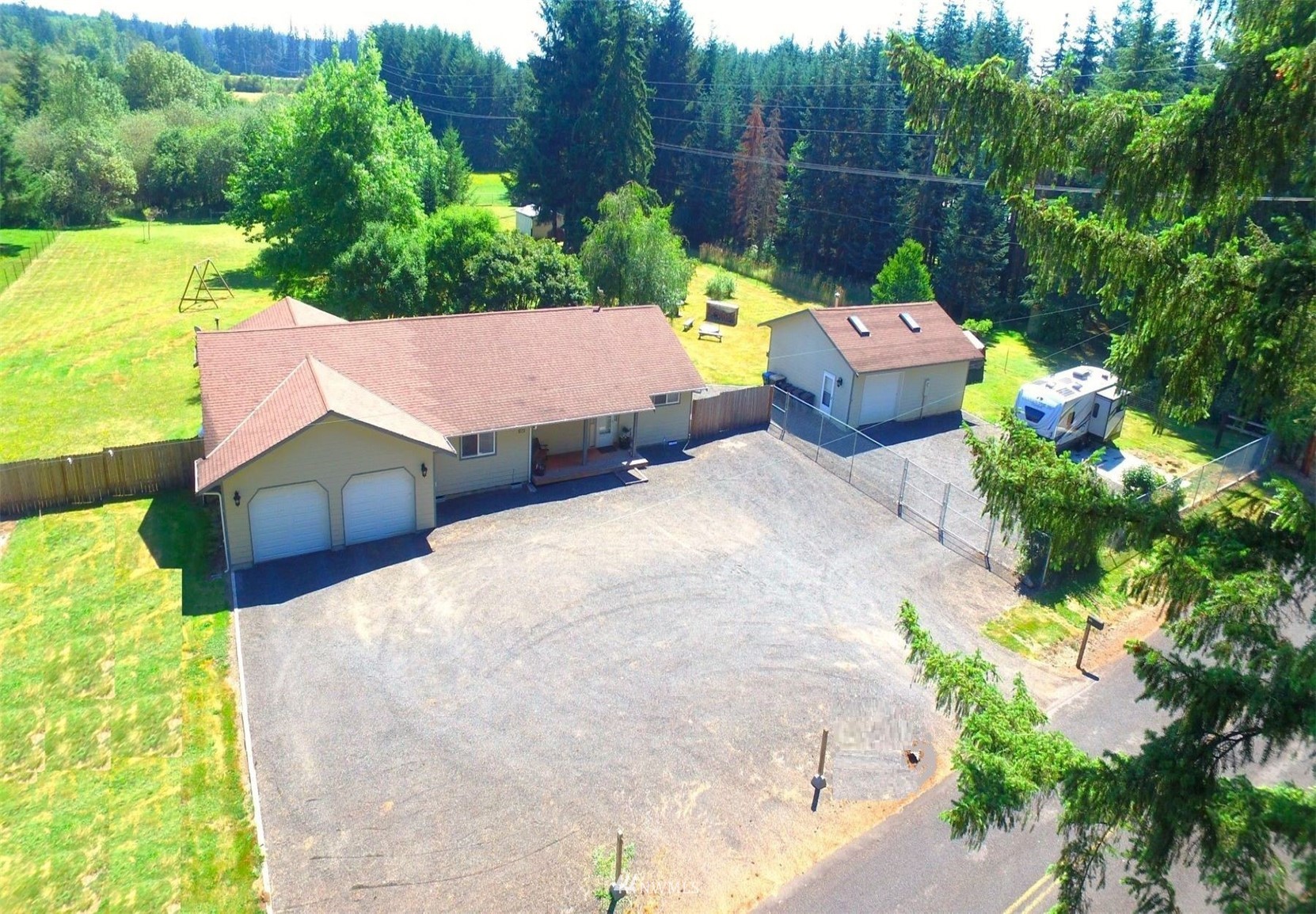an aerial view of a house with swimming pool garden and patio