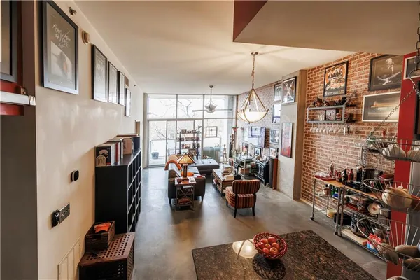 a living room with furniture a rug and a chandelier