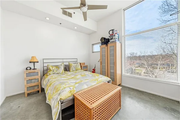 a bedroom with a bed and cabinets