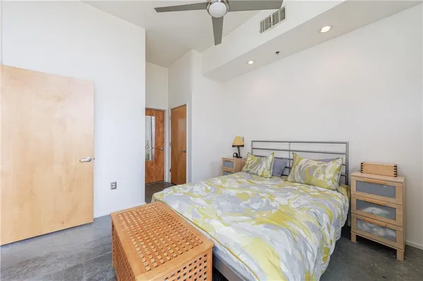 a bedroom with a bed and a painting on the wall