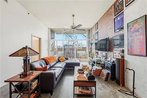 a living room with patio furniture and a chandelier