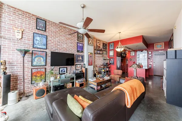a view of a livingroom with furniture and a flat screen tv