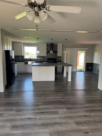 a kitchen with stainless steel appliances granite countertop a stove and cabinets