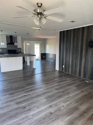 a view of a livingroom with hardwood floor and a ceiling fan
