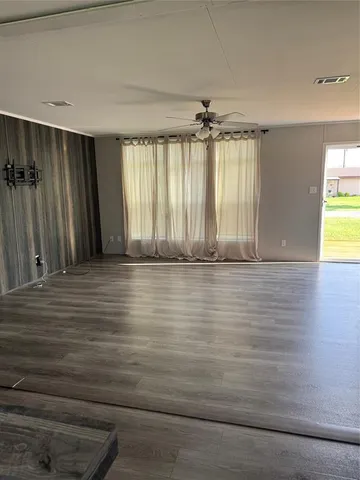 a kitchen with granite countertop wooden floors and wide window