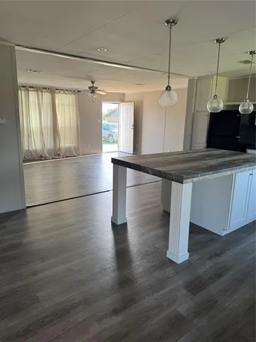 a view of a room with wooden floor and fan