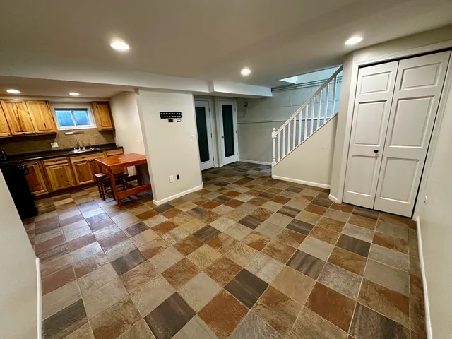 a view of a livingroom with furniture and an entryway