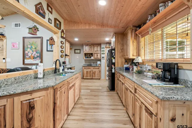 a kitchen with granite countertop a stove and a sink