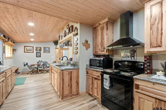 a kitchen with stainless steel appliances granite countertop a stove and a sink