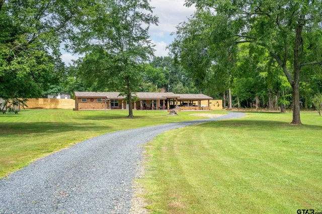a view of a swimming pool with a yard