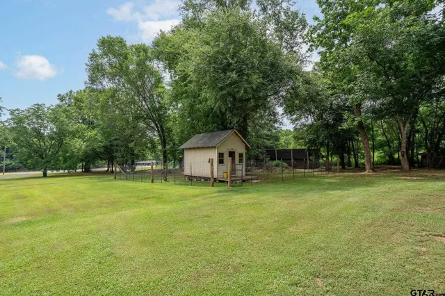 an aerial view of a residential houses with outdoor space and street view