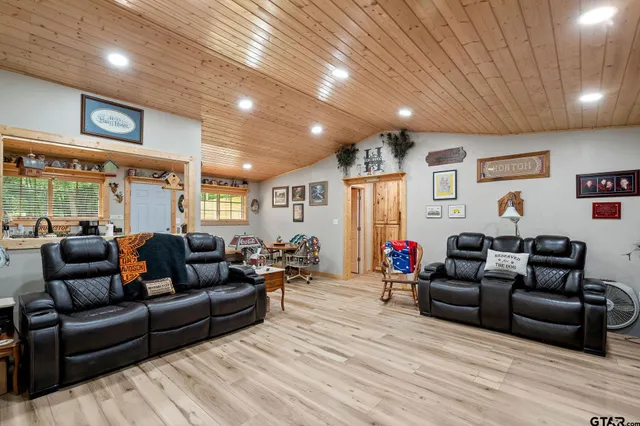 a living room with furniture flat screen tv and a fireplace