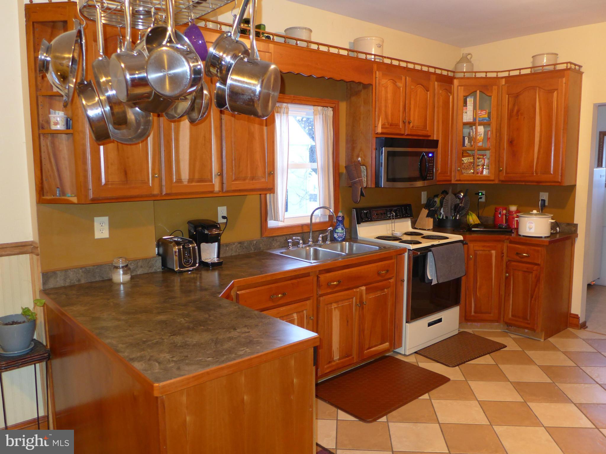 14633 Pennersville Road Cascade, MD 21719 - Photo 5 of 29 a kitchen with stainless steel appliances granite countertop a sink a stove counter space and cabinets