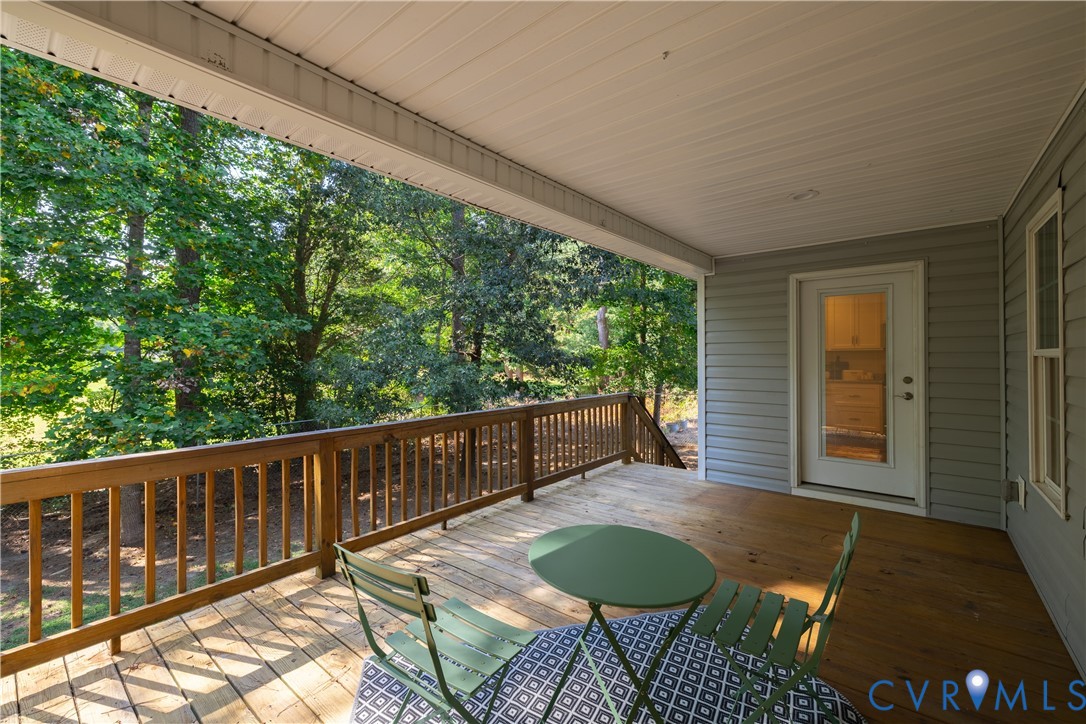 6720 Claiborne Road Sutherland, VA 23885 - Photo 27 of 35 Covered wood deck with wood railing, light gray si