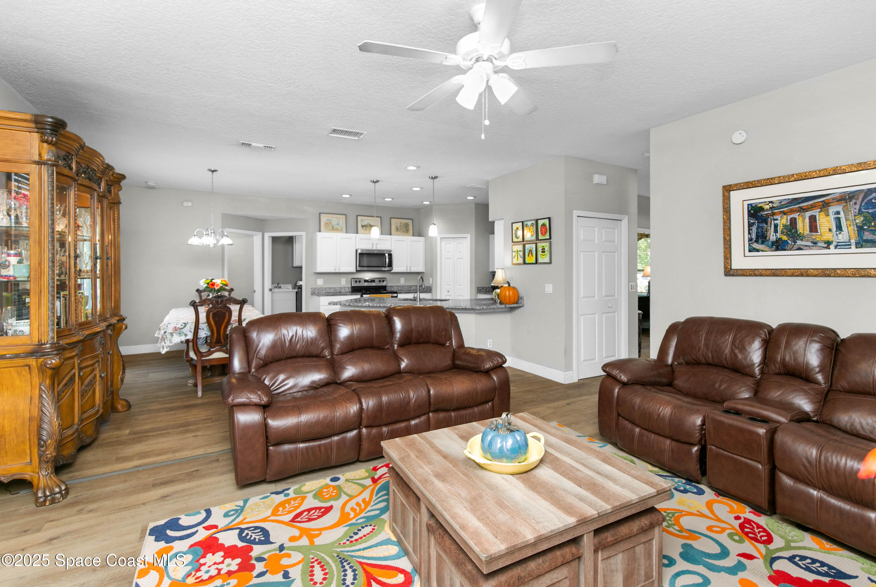 3530 Big Pine Road Melbourne, FL 32934 - Photo 12 of 39 a living room with furniture and wooden floor