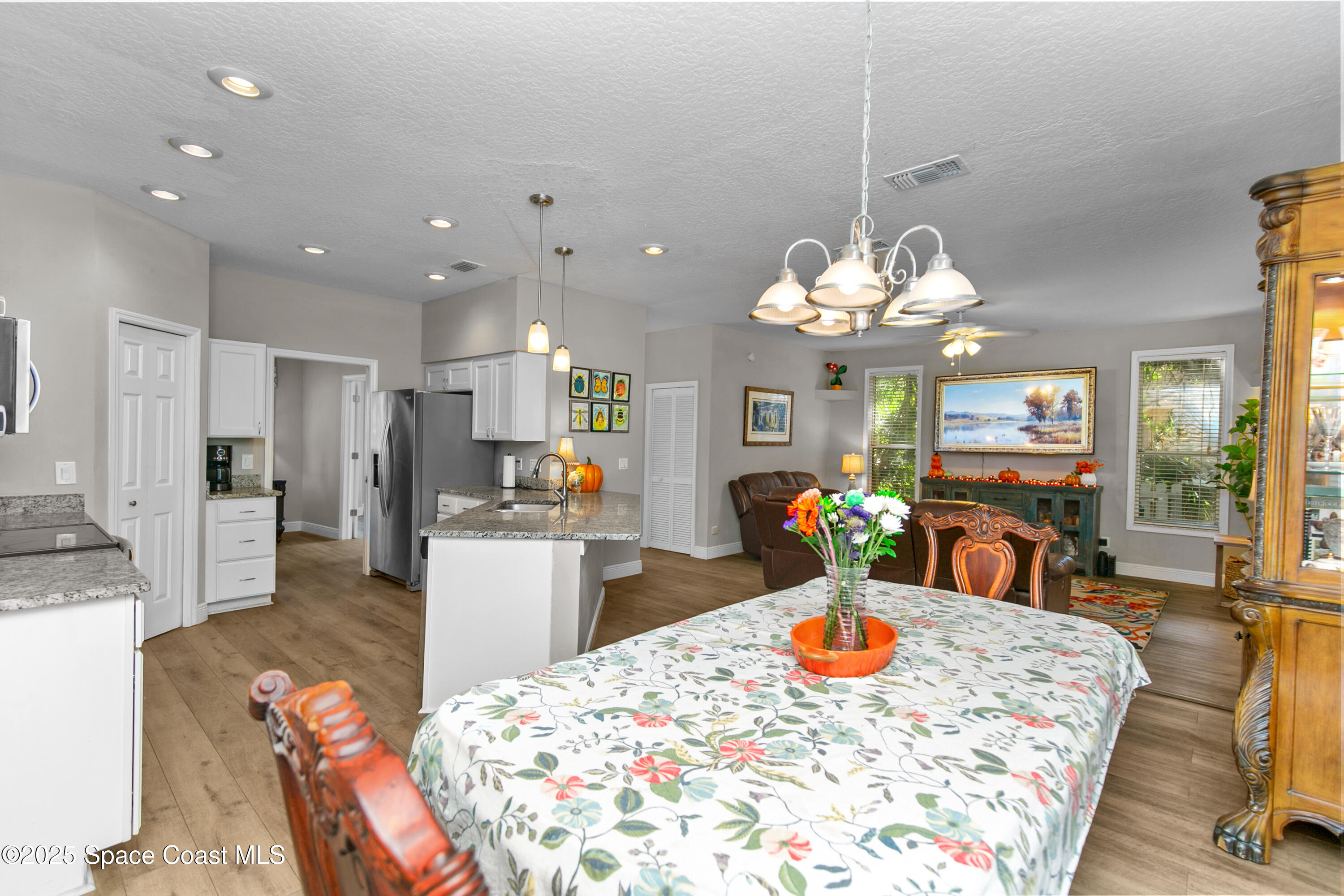3530 Big Pine Road Melbourne, FL 32934 - Photo 14 of 39 a kitchen with stainless steel appliances kitchen island granite countertop a sink and cabinets