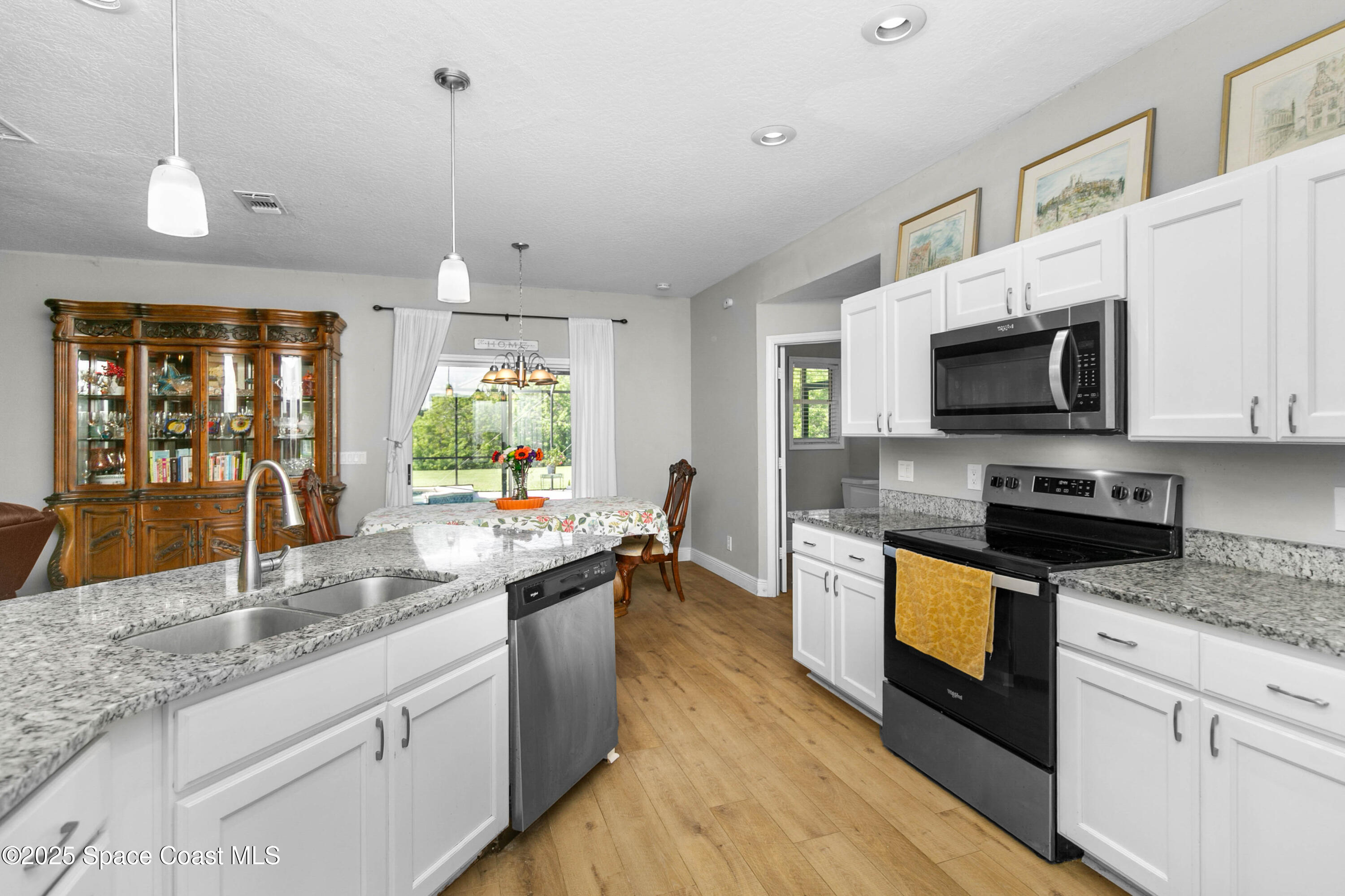 3530 Big Pine Road Melbourne, FL 32934 - Photo 15 of 39 a kitchen with stainless steel appliances granite countertop a stove a sink and a microwave