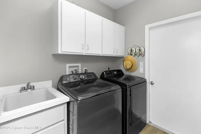 a view of washer and dryer with bathroom