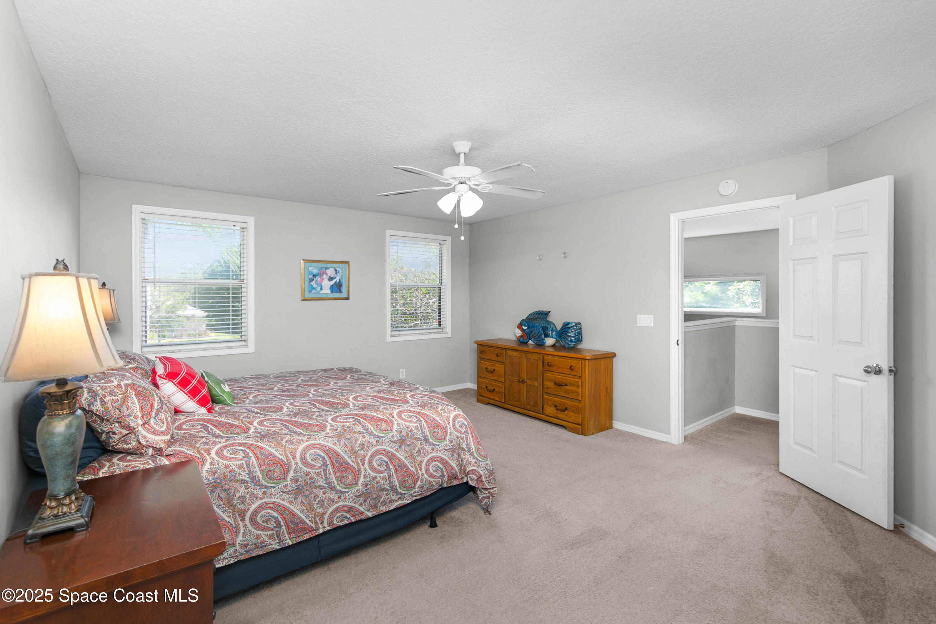 3530 Big Pine Road Melbourne, FL 32934 - Photo 19 of 39 a bed room with a bed and a chandelier
