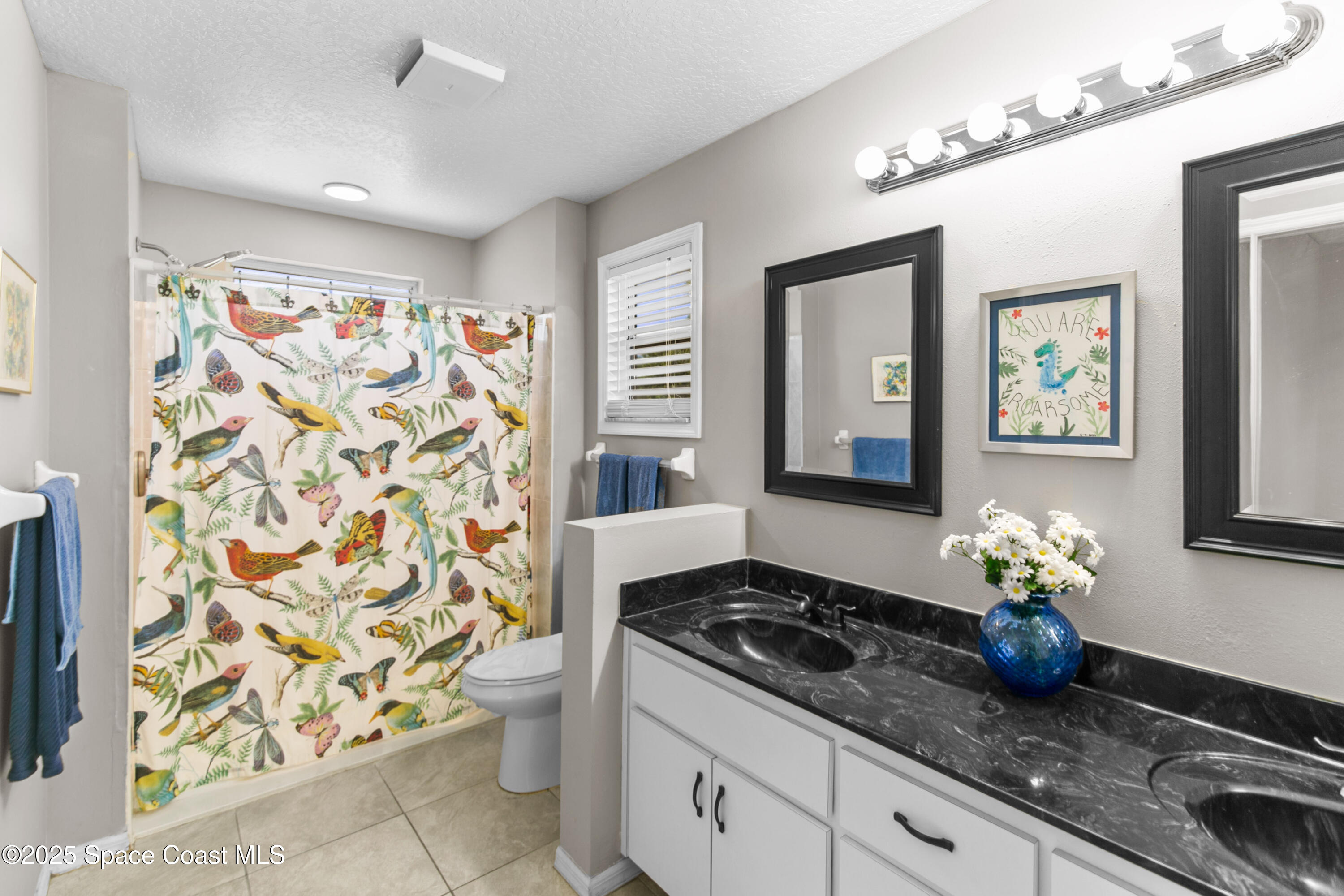 3530 Big Pine Road Melbourne, FL 32934 - Photo 20 of 39 a kitchen with stainless steel appliances a stove a chimney a sink and cabinets
