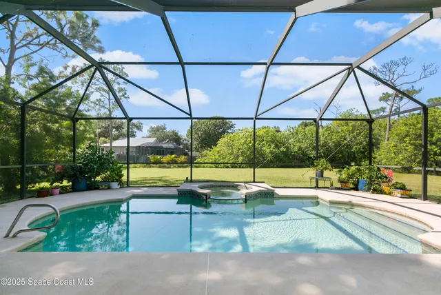 a view of a patio with a table and chairs under an umbrella