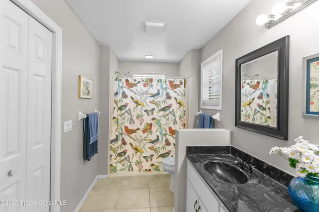 a kitchen with stainless steel appliances granite countertop a refrigerator a stove and a wooden floor