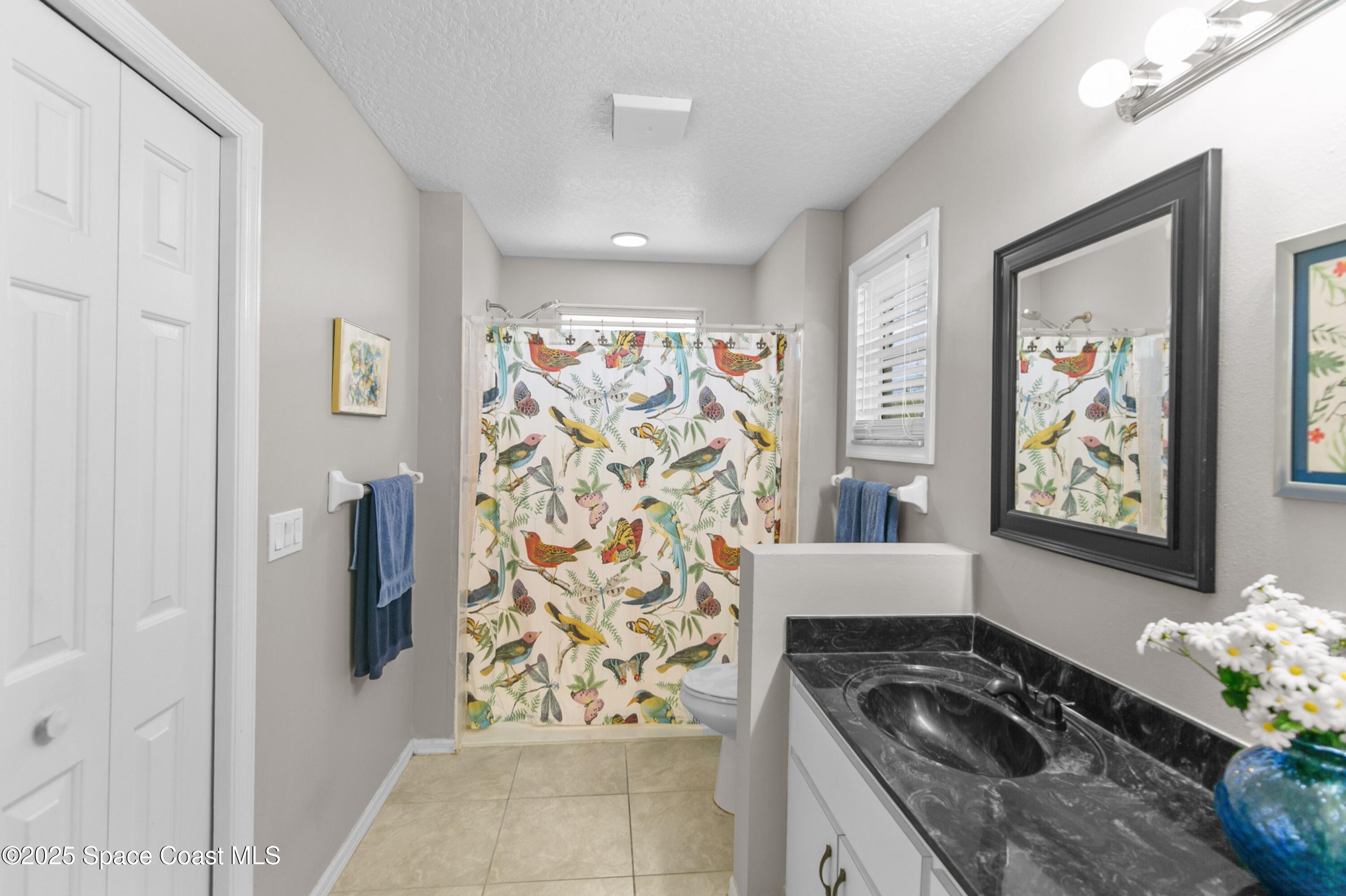 3530 Big Pine Road Melbourne, FL 32934 - Photo 21 of 39 a kitchen with stainless steel appliances granite countertop a refrigerator a stove and a wooden floor