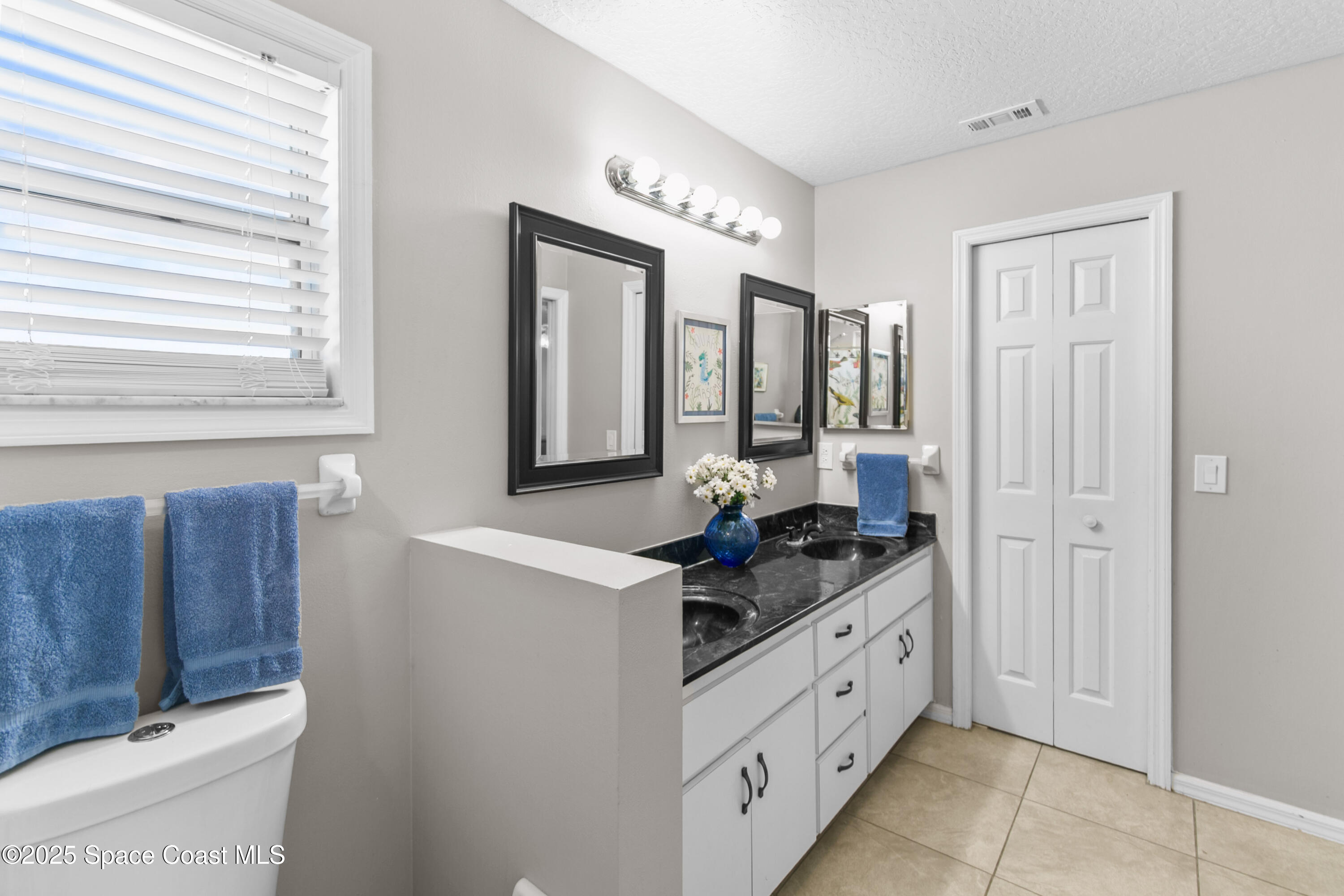 3530 Big Pine Road Melbourne, FL 32934 - Photo 22 of 39 a spacious bathroom with a granite countertop sink and a mirror