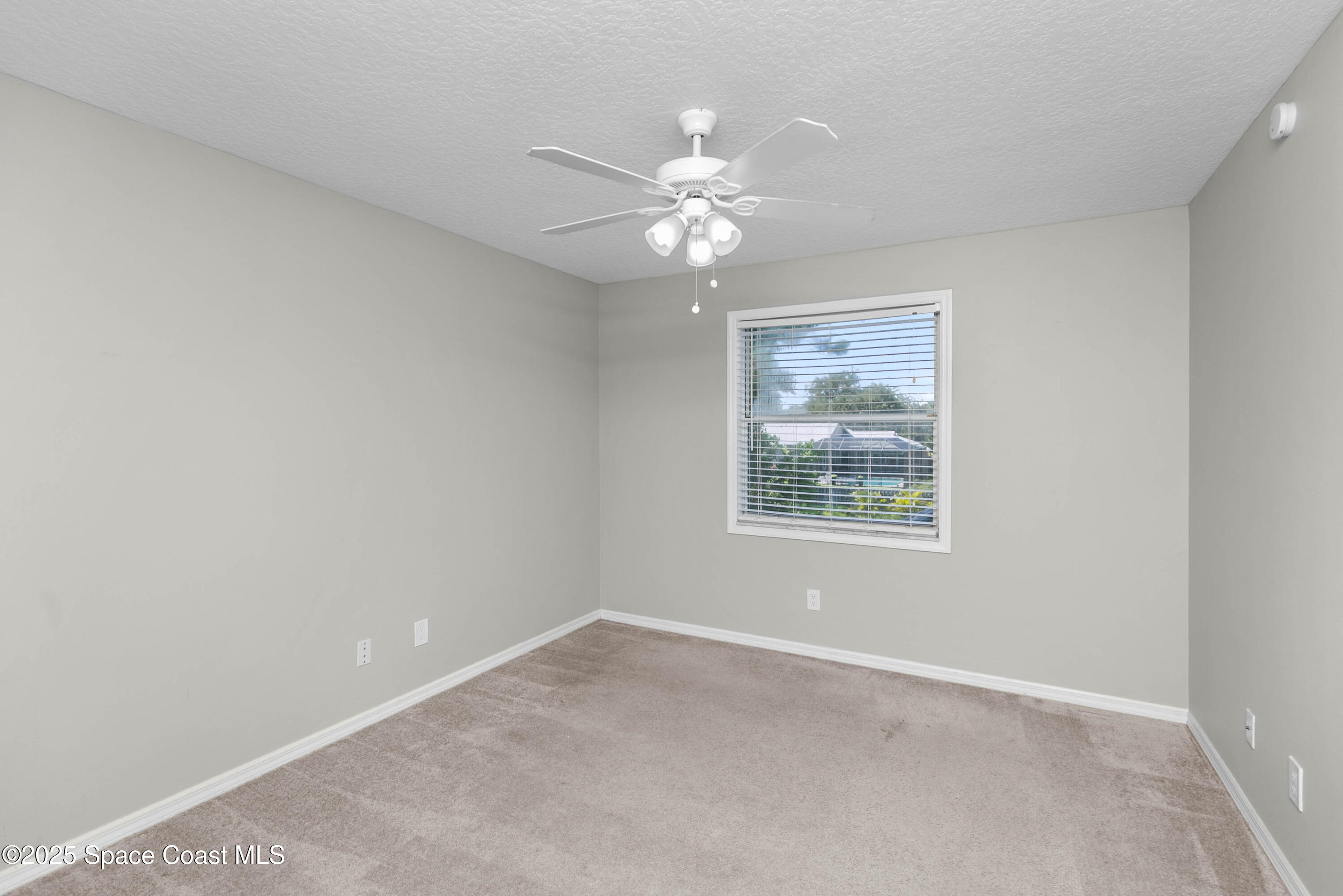 3530 Big Pine Road Melbourne, FL 32934 - Photo 23 of 39 an empty room with a window and a fan