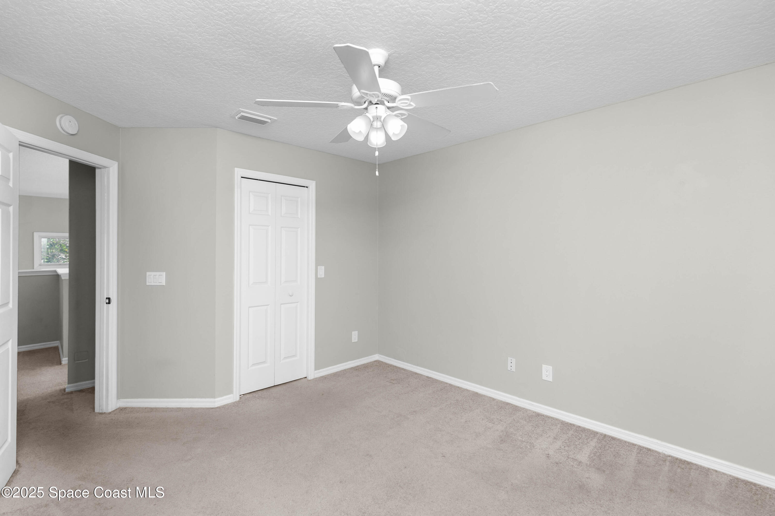 3530 Big Pine Road Melbourne, FL 32934 - Photo 24 of 39 an empty room with a ceiling fan and a window
