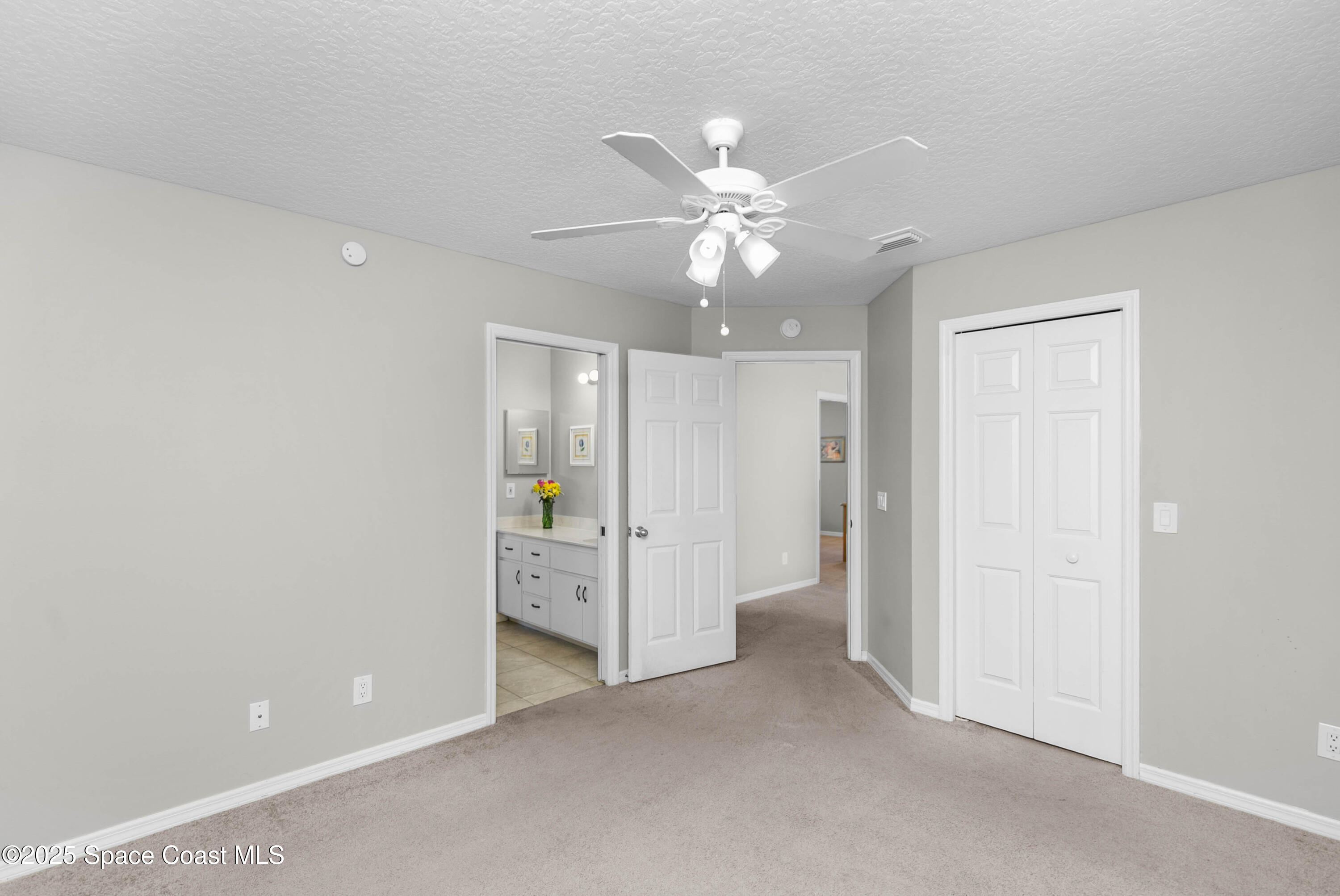 3530 Big Pine Road Melbourne, FL 32934 - Photo 25 of 39 an empty room with closet and a ceiling fan