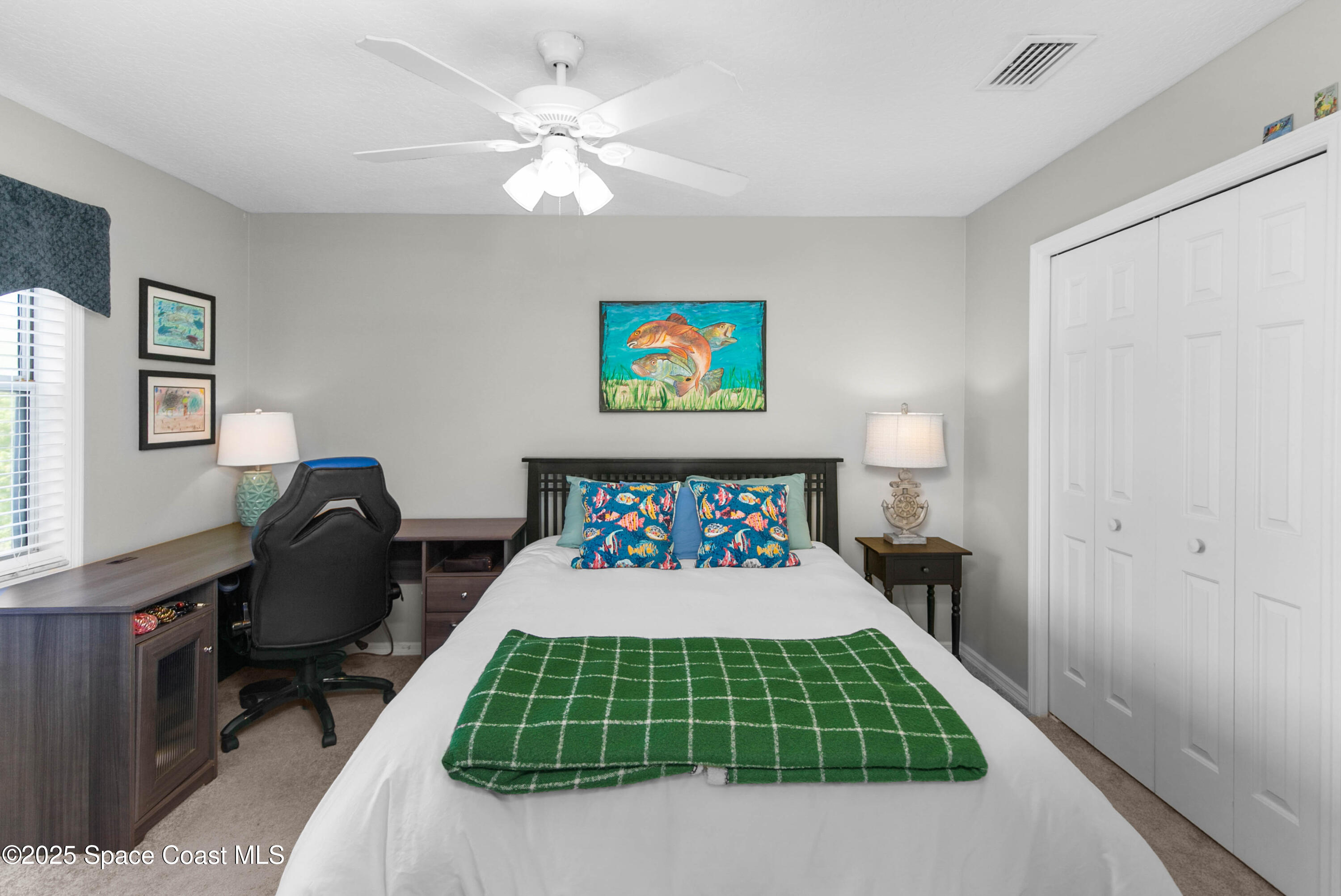 3530 Big Pine Road Melbourne, FL 32934 - Photo 28 of 39 a bedroom with a bed and a chair