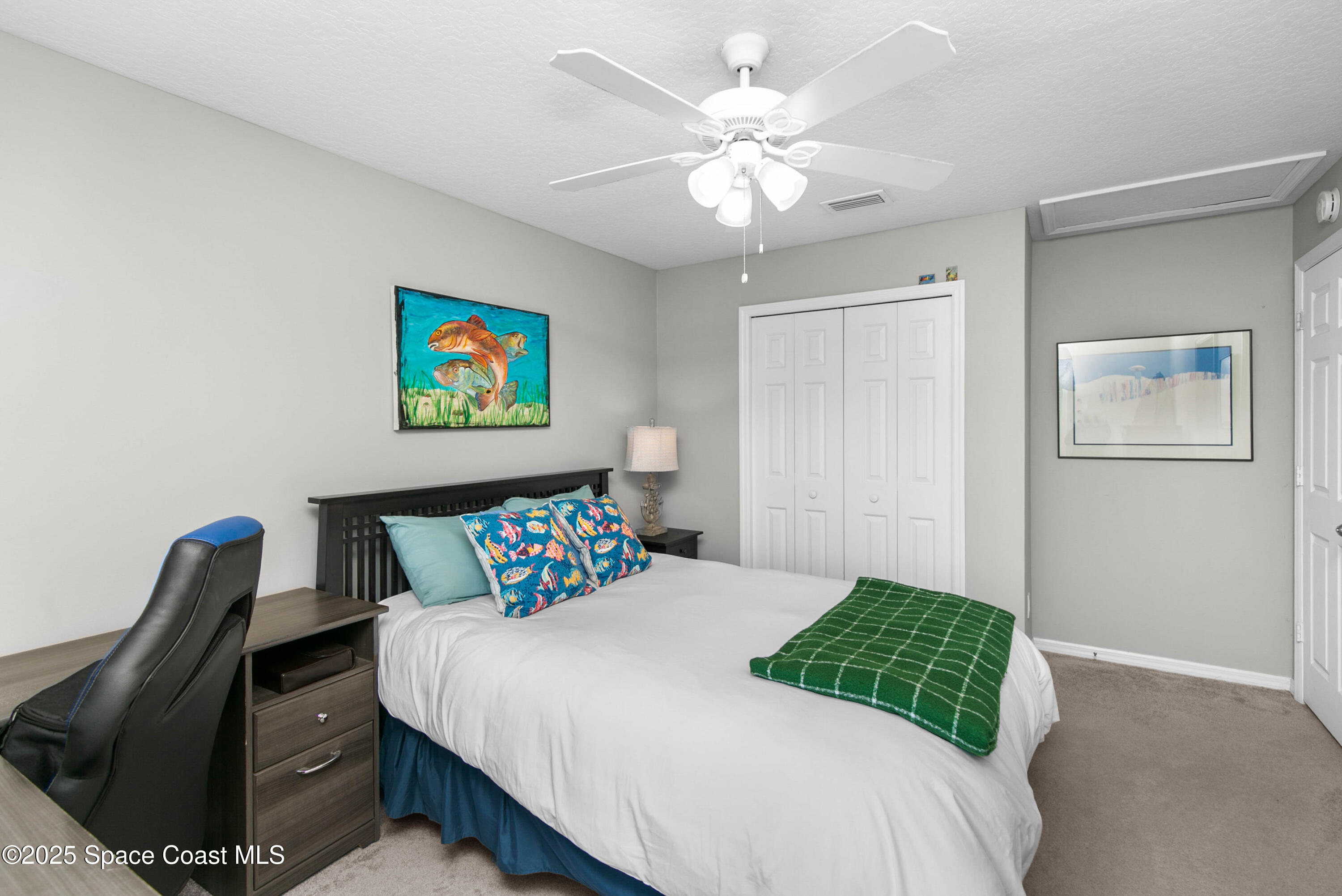 3530 Big Pine Road Melbourne, FL 32934 - Photo 29 of 39 a bedroom with a bed and a painting on the wall