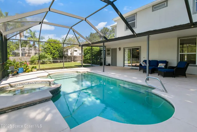 a swimming pool with outdoor seating yard and outdoor seating