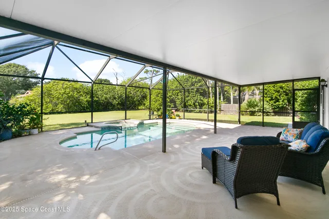 a view of a floor to ceiling window and a table in chairs