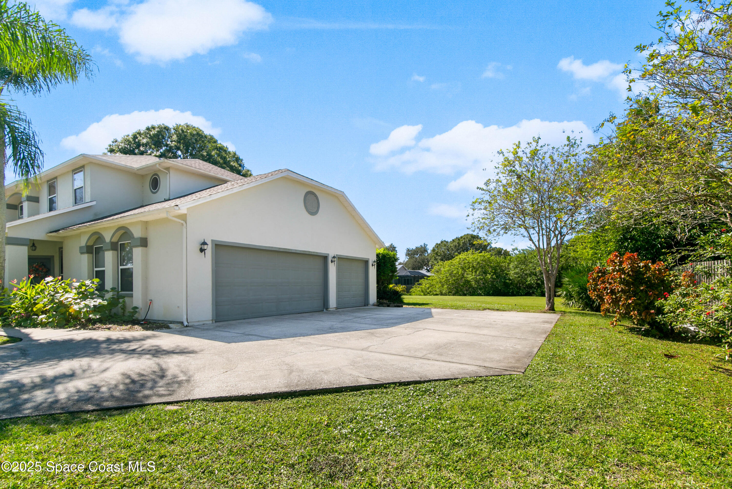 3530 Big Pine Road Melbourne, FL 32934 - Photo 37 of 39 a front view of a house with a yard and garage