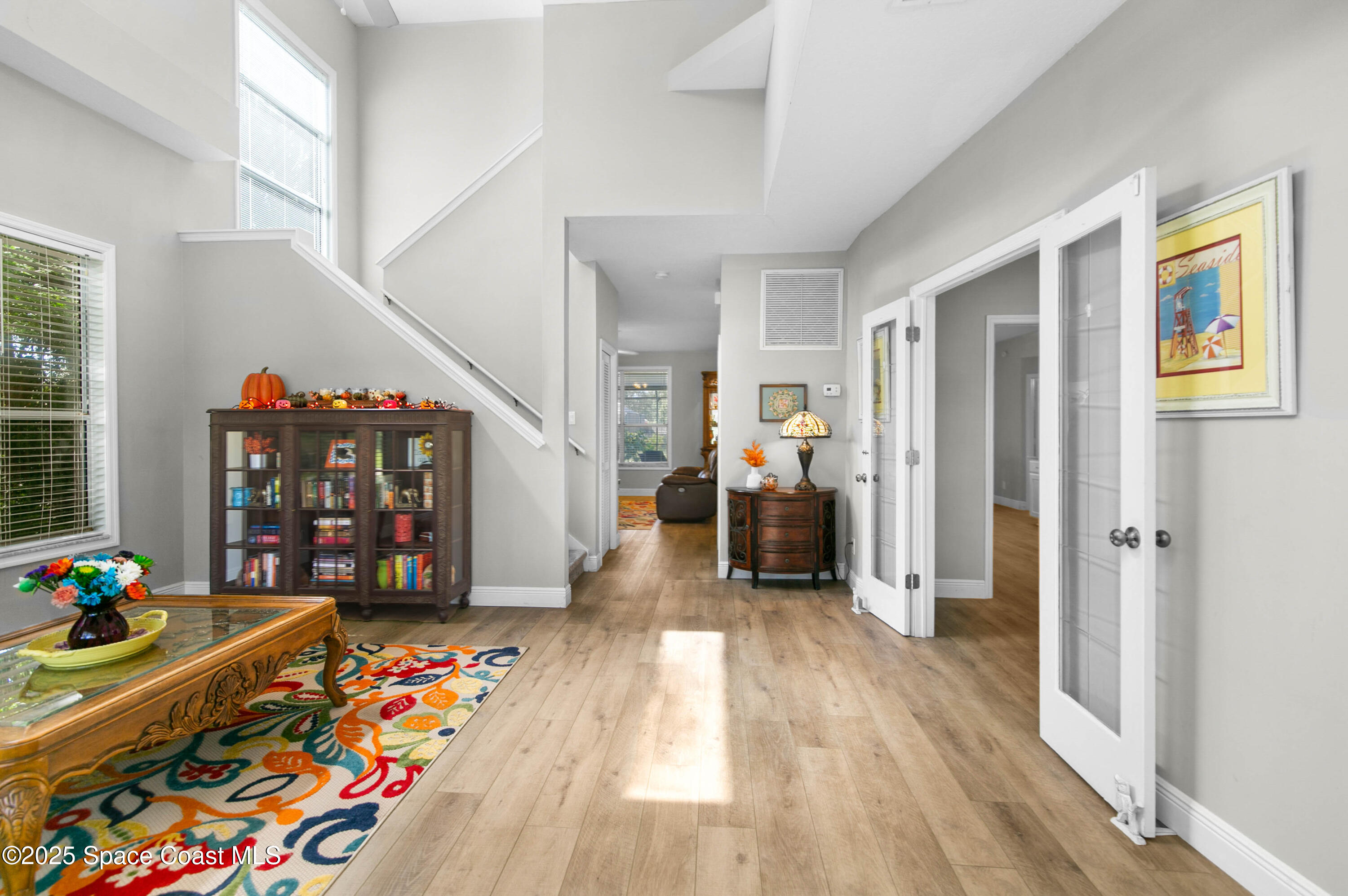 3530 Big Pine Road Melbourne, FL 32934 - Photo 4 of 39 a hallway with toys and wooden floor