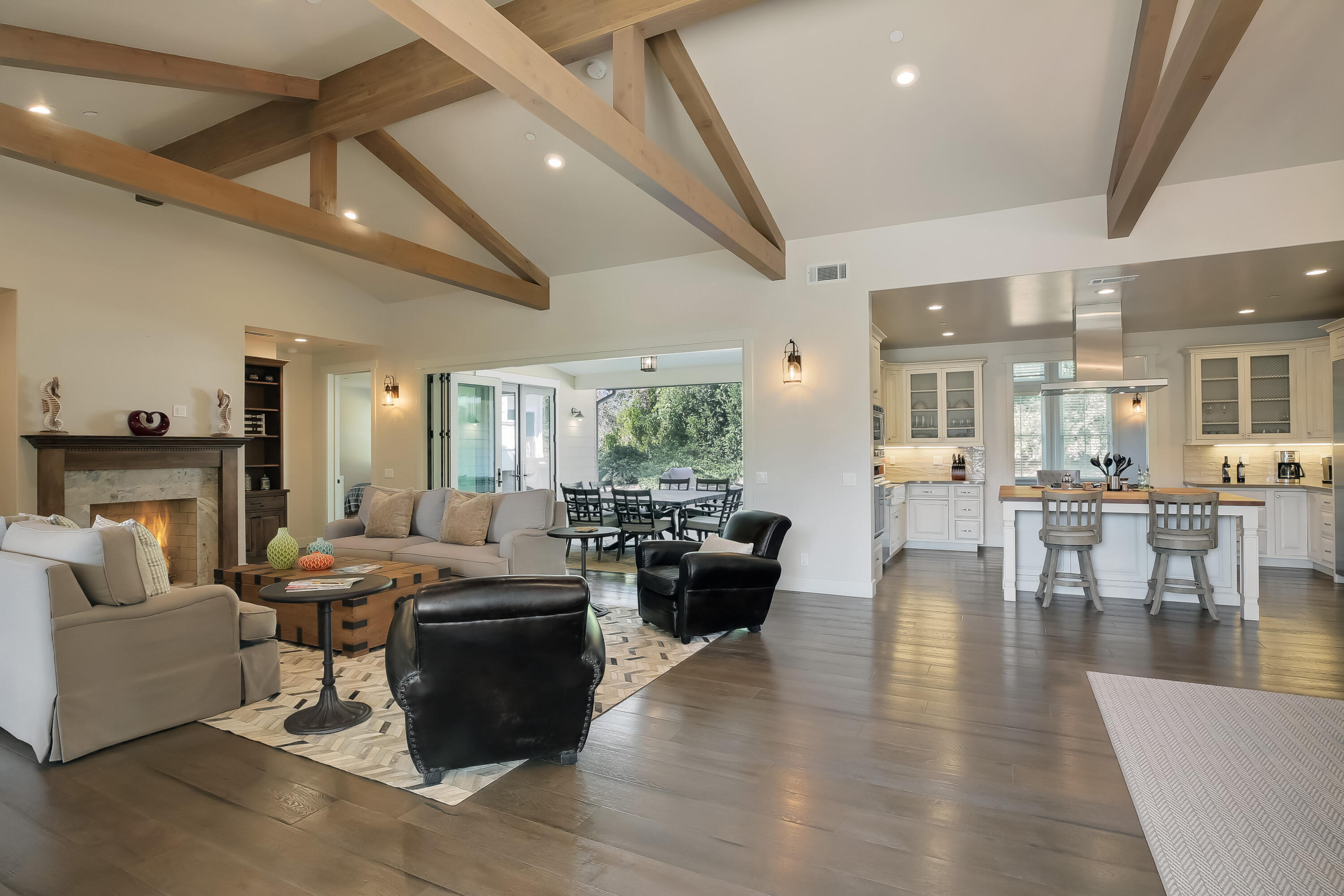 a living room with fireplace furniture and a large window