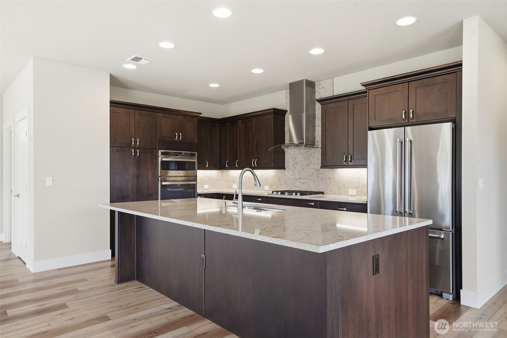 35 Viking Way Sequim, WA 98382 - Photo 13 of 39 a kitchen with stainless steel appliances granite countertop a refrigerator a sink and wooden cabinets