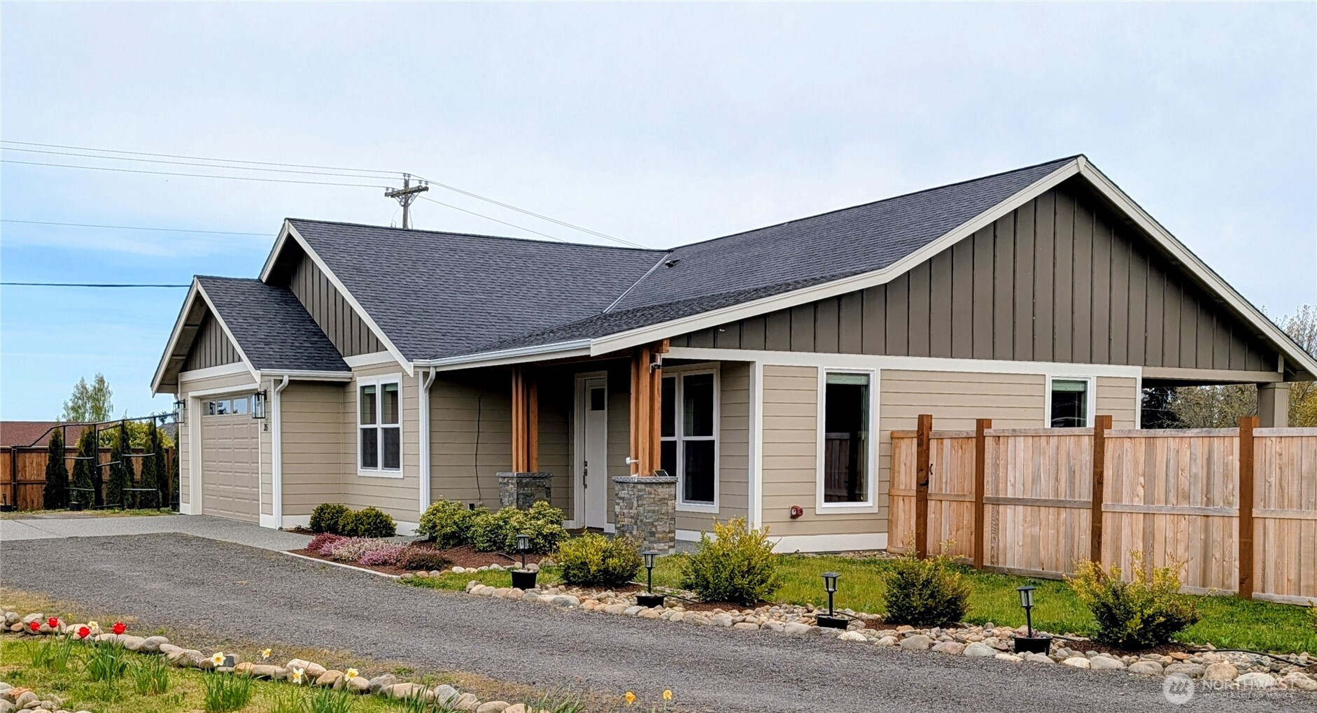 35 Viking Way Sequim, WA 98382 - Photo 2 of 39 a front view of a house with a yard and potted plants