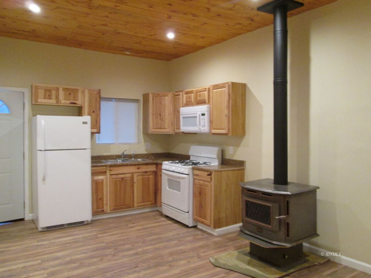 52810 Pine Cove Road Idyllwild, CA 92549 - Photo 8 of 21 a kitchen with a refrigerator and a stove top oven