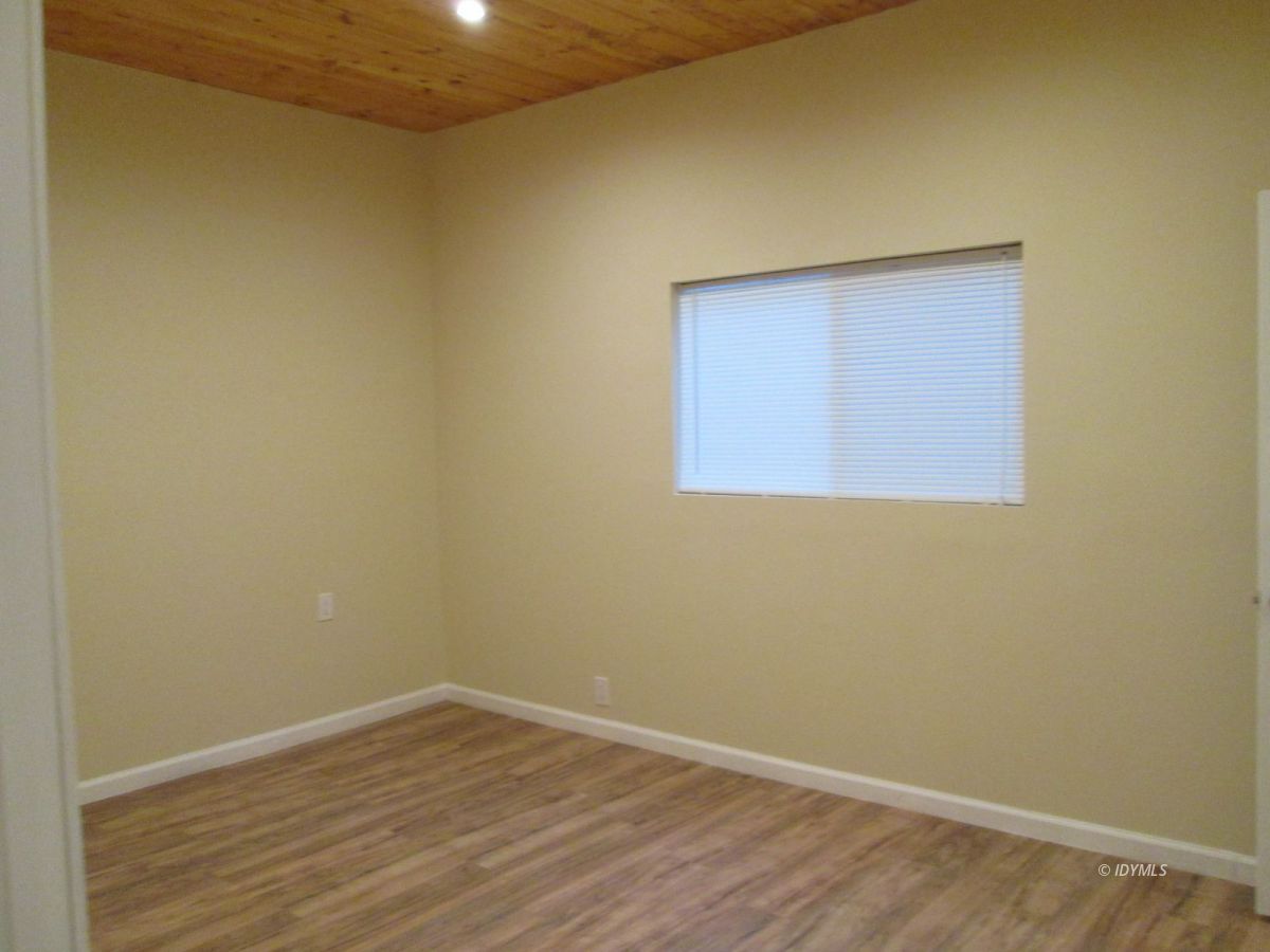 52810 Pine Cove Road Idyllwild, CA 92549 - Photo 9 of 21 an empty room with wooden floor and windows