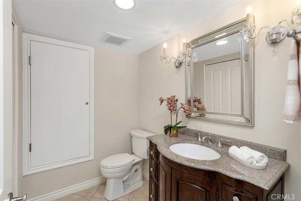28102 Pinnacles Court Laguna Niguel, CA 92677 - Photo 12 of 30 a bathroom with a toilet a sink and mirror