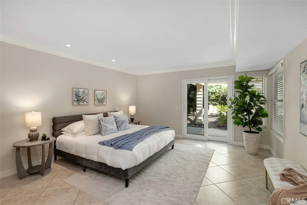 28102 Pinnacles Court Laguna Niguel, CA 92677 - Photo 13 of 30 a spacious bedroom with a bed and a potted plant