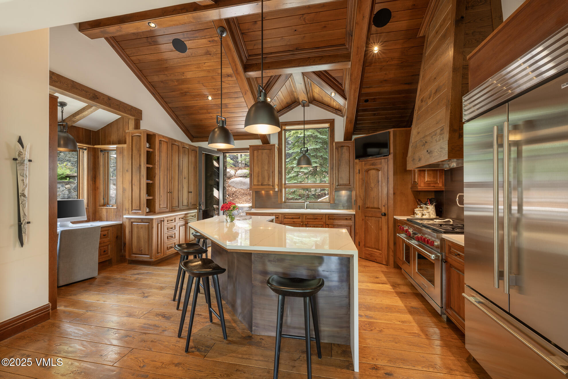 185 Forest Road Vail, CO 81657 - Photo 2 of 13 a large kitchen with stainless steel appliances granite countertop a large window and a counter top space