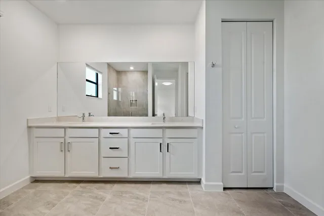 a spacious bathroom with a mirror and a sink