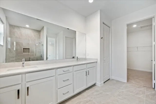 a bathroom with a granite countertop sink mirror and double