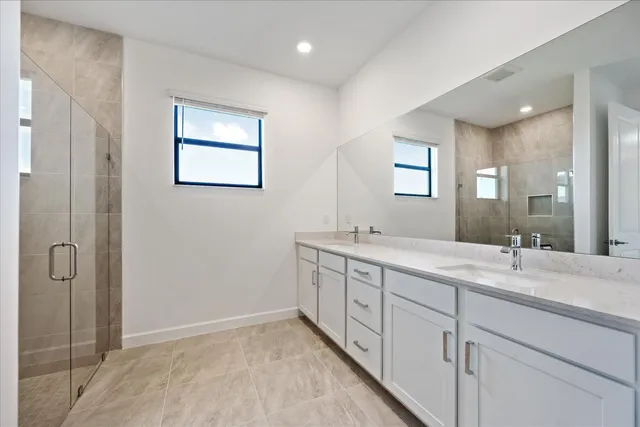 a bathroom with 2 sink tub and a mirror