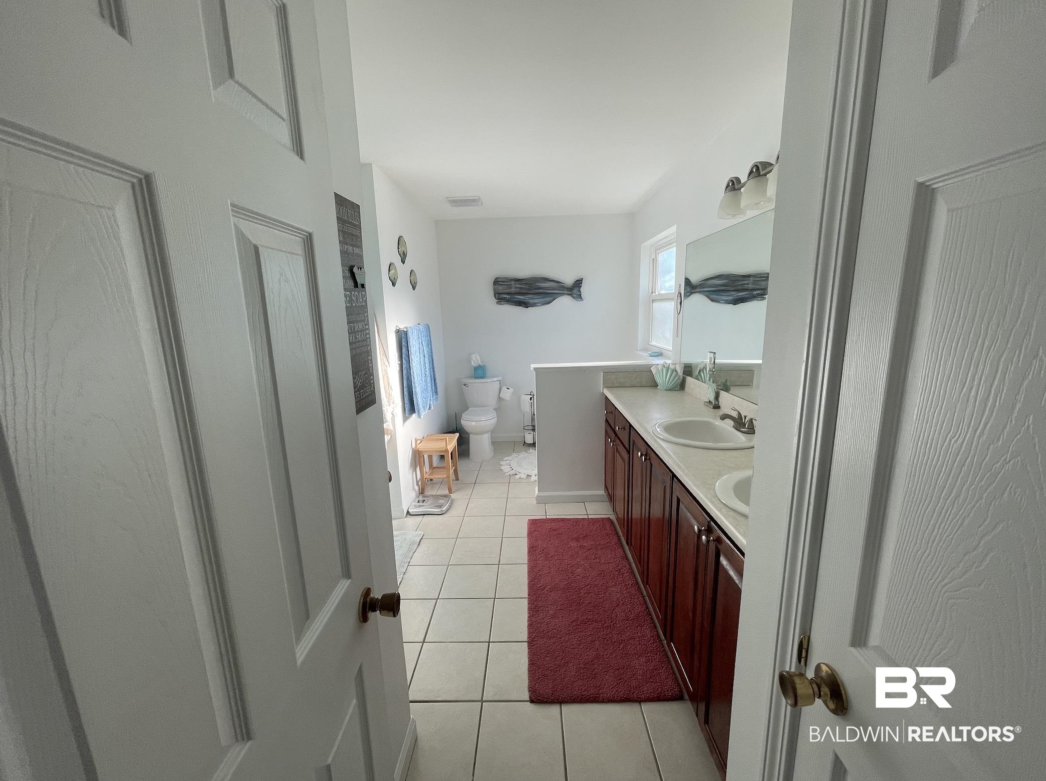 17643 East View Loop Foley, AL 36535 - Photo 17 of 25 Bathroom featuring toilet, a sink, baseboards, tile patterned floors, and double vanity